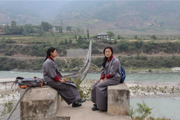 Students waiting to cross the longest suspension bridge in Punakha.